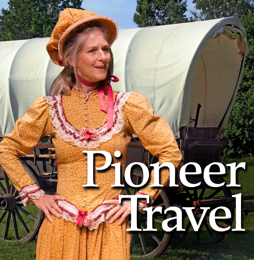 A woman in yellow dress and hat standing next to a covered wagon.