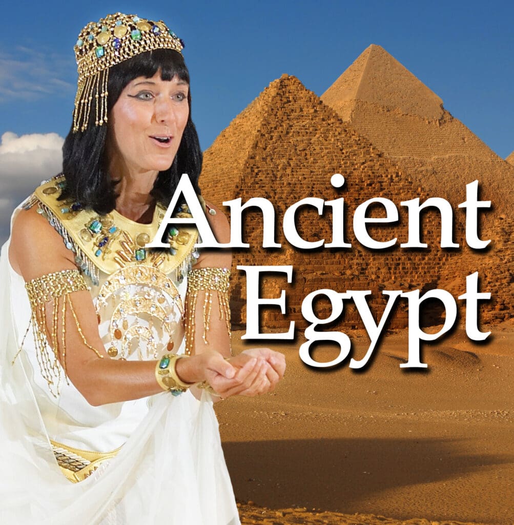 9 A woman in egyptian costume standing next to pyramids.