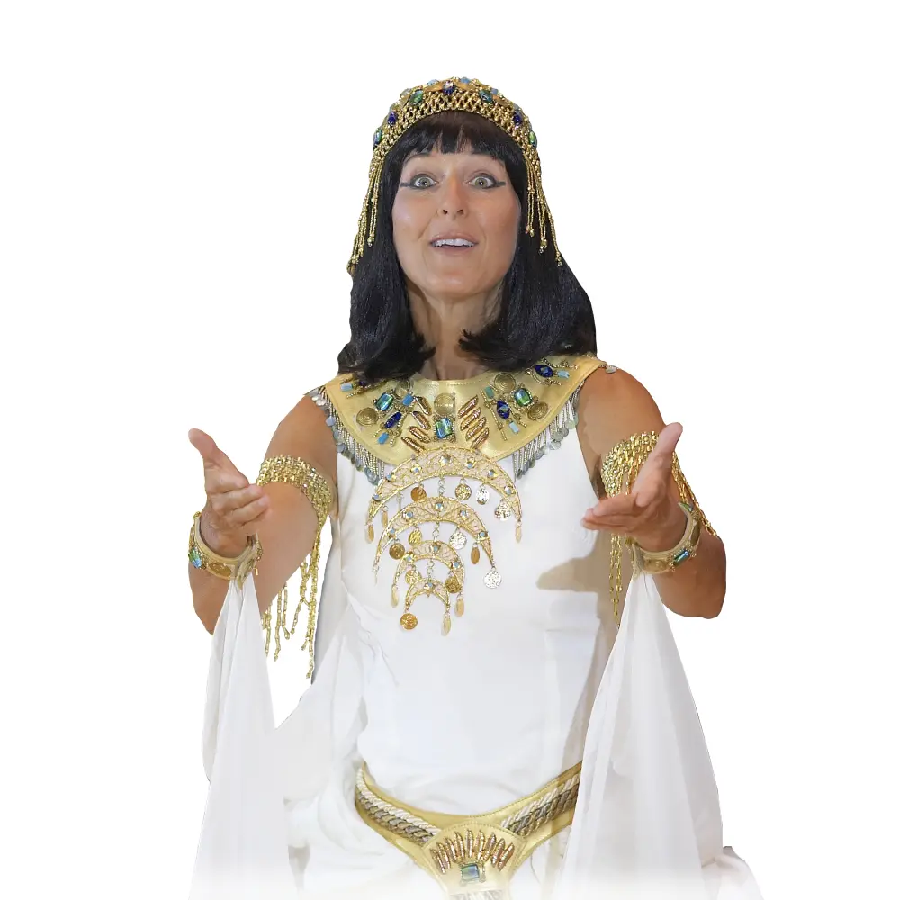 A woman dressed as cleopatra pointing to her chest.