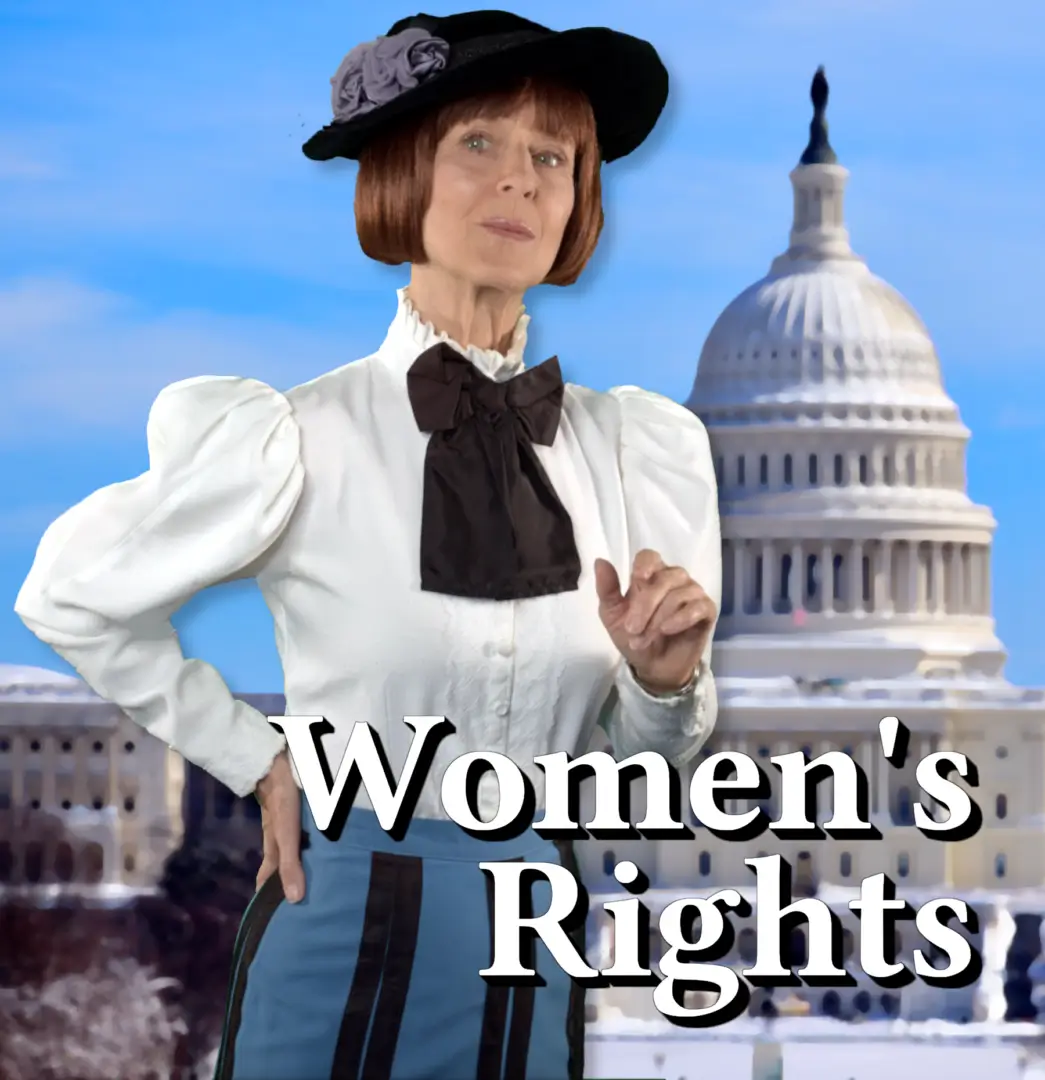 A woman in a hat and blouse standing next to the capitol building.