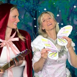 Two women dressed as little red riding hood and a fairy